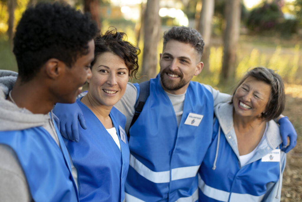 Smiling employees in uniform standing together during a work shift, representing recognition and team culture.